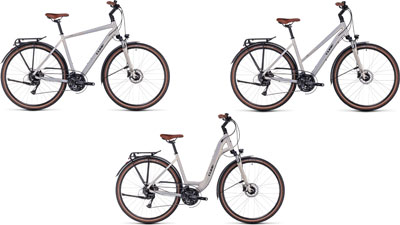 Trois vélos Cube Touring Pro côte à côte : un avec un cadre diamant, un avec un cadre trapèze et un avec un cadre bas.